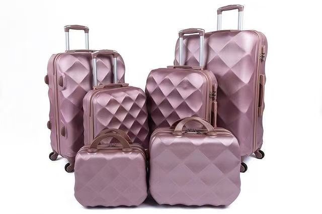 Rose-colored luggage set with a diamond-pattern shell